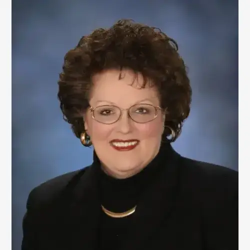 A woman with glasses and black jacket