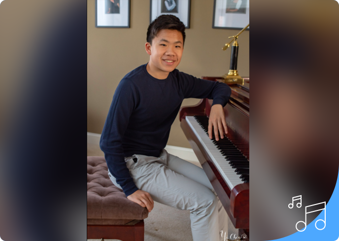 A man sitting on top of a piano.